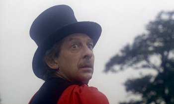 Movie still from “Wonderwall” (1968), directed by Joe Massot – A person wearing a top hat; Close Up shot, Low angle