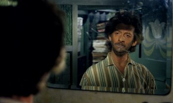 Movie still from “Wonderwall” (1968), directed by Joe Massot – A man looking at himself in the mirror; Close Up shot, Over the shoulder angle