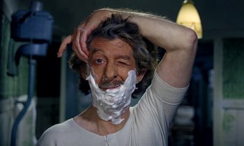 Movie still from “Wonderwall” (1968), directed by Joe Massot – A man shaving his face with a white shaving foam; Close Up shot, Over the shoulder angle