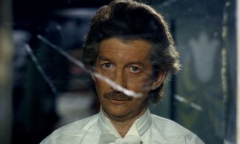 Movie still from “Wonderwall” (1968), directed by Joe Massot – A person wearing a shirt and tie; Close Up shot, High angle