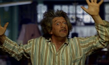 Movie still from “Wonderwall” (1968), directed by Joe Massot – An older man with a surprised look on his face; Medium shot, Low angle