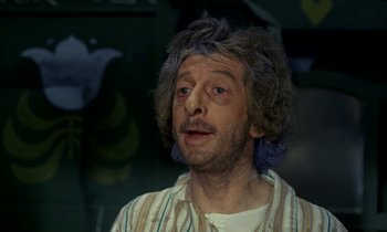 Movie still from “Wonderwall” (1968), directed by Joe Massot – A man with blue hair and a beard and mustache; Close Up shot, High angle