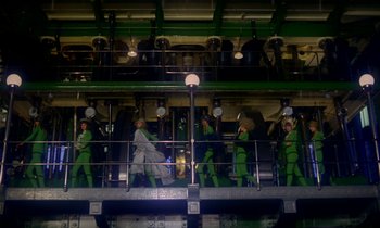 Movie still from “Wonderwall” (1968), directed by Joe Massot – A group of people standing on top of a building; Extreme Wide shot, Low angle