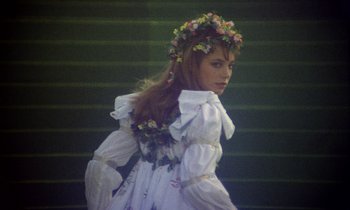 Movie still from “Wonderwall” (1968), directed by Joe Massot – A woman in a white dress and a flower crown; Medium shot, Low angle