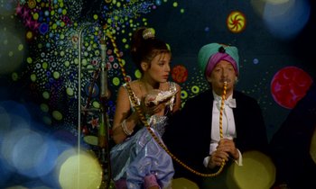 Movie still from “Wonderwall” (1968), directed by Joe Massot – A man and a woman dressed up as a genie and princess; Medium shot, Low angle