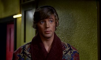 Movie still from “Wonderwall” (1968), directed by Joe Massot – A person wearing a sweater; Close Up shot, Over the shoulder angle