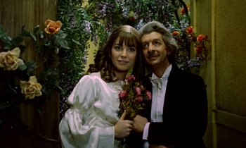 Movie still from “Wonderwall” (1968), directed by Joe Massot – A man and a woman posing for a picture; Close Up shot, Low angle