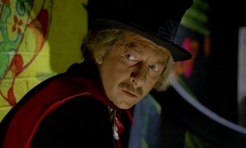 Movie still from “Wonderwall” (1968), directed by Joe Massot – A person wearing a hat; Close Up shot, Low angle