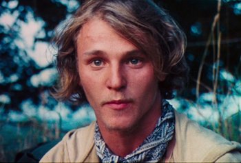 Movie still from “Woodstock” (1970), directed by Michael Wadleigh – A person with long blonde hair; Close Up shot, High angle