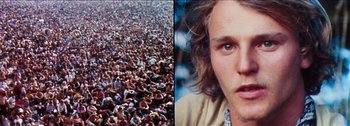 Movie still from “Woodstock” (1970), directed by Michael Wadleigh – A man with long hair is in the middle of a large crowd; Close Up shot, Overhead angle