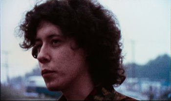 Movie still from “Woodstock” (1970), directed by Michael Wadleigh – A person with curly hair; Close Up shot, Low angle