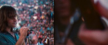 Movie still from “Woodstock” (1970), directed by Michael Wadleigh – A blurry image of a crowd of people in the street; Close Up shot, High angle