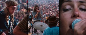 Movie still from “Woodstock” (1970), directed by Michael Wadleigh – A crowd of people watching a man play a musical instrument; Medium shot, High angle