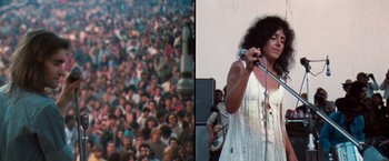 Movie still from “Woodstock” (1970), directed by Michael Wadleigh – A woman in a white dress holding a microphone in front of a crowd of onlookers; Medium shot, High angle