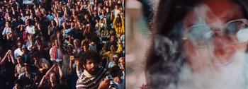 Movie still from “Woodstock” (1970), directed by Michael Wadleigh – A crowd of people sitting and standing in front of an audience; Medium shot, High angle