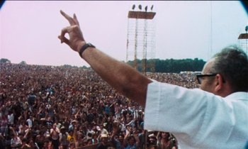 Movie still from “Woodstock” (1970), directed by Michael Wadleigh – A crowd of people at an outdoor concert; Medium shot, Low angle