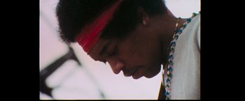 Movie still from “Woodstock” (1970), directed by Michael Wadleigh – A person wearing a red headband; Close Up shot, Low angle