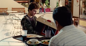 Movie still from “World's Greatest Dad” (2009), directed by Bobcat Goldthwait – Two people sitting at a table with plates of food; Medium shot, Over the shoulder angle