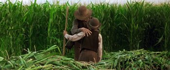 Movie still from “Wyatt Earp” (1994), directed by Lawrence Kasdan – Two people in a field hugging each other; Medium shot, Over the shoulder angle