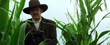 Movie still from “Wyatt Earp” (1994), directed by Lawrence Kasdan – An old man in a hat and a suit and a hat; Medium shot, Low angle