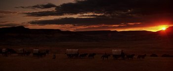 Movie still from “Wyatt Earp” (1994), directed by Lawrence Kasdan – A group of people riding horses on a dirt field; Extreme Wide shot, Low angle