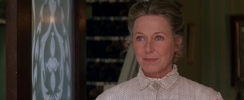 Movie still from “Wyatt Earp” (1994), directed by Lawrence Kasdan – An older woman wearing a polka dot shirt; Close Up shot, Over the shoulder angle