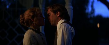 Movie still from “Wyatt Earp” (1994), directed by Lawrence Kasdan – A man and a woman standing next to each other; Close Up shot, Low angle