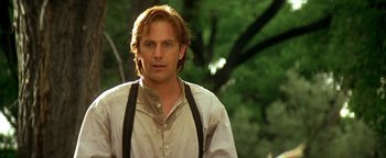 Movie still from “Wyatt Earp” (1994), directed by Lawrence Kasdan – A person wearing a shirt and tie; Close Up shot, Over the shoulder angle