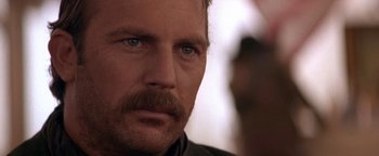 Movie still from “Wyatt Earp” (1994), directed by Lawrence Kasdan – A person with a mustache; Close Up shot, Over the shoulder angle