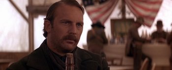 Movie still from “Wyatt Earp” (1994), directed by Lawrence Kasdan – A person with a beard and mustache; Close Up shot, Over the shoulder angle