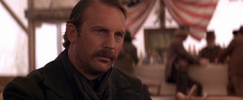 Movie still from “Wyatt Earp” (1994), directed by Lawrence Kasdan – A person with a mustache; Close Up shot, Over the shoulder angle