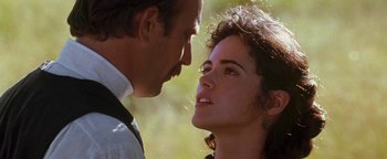 Movie still from “Wyatt Earp” (1994), directed by Lawrence Kasdan – A man and a woman face to face in a field; Close Up shot, Over the shoulder angle
