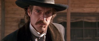 Movie still from “Wyatt Earp” (1994), directed by Lawrence Kasdan – A person wearing a hat; Close Up shot, Low angle