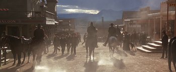 Movie still from “Wyatt Earp” (1994), directed by Lawrence Kasdan – A group of men riding horses down a dirt road; Extreme Wide shot, Low angle