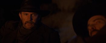 Movie still from “Wyatt Earp” (1994), directed by Lawrence Kasdan – A man with a beard wearing a cowboy hat; Close Up shot, Over the shoulder angle