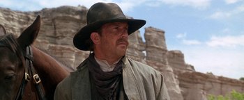 Movie still from “Wyatt Earp” (1994), directed by Lawrence Kasdan – A man wearing a hat and a cowboy outfit; Close Up shot, Low angle