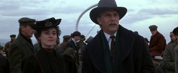 Movie still from “Wyatt Earp” (1994), directed by Lawrence Kasdan – A man and a woman are walking in a crowd; Close Up shot, Low angle