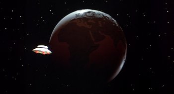 Movie still from “Xanadu” (1980), directed by Robert Greenwald – An image of an earth with a space ship in the background; Extreme Wide shot, High angle