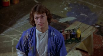 Movie still from “Xanadu” (1980), directed by Robert Greenwald – A man in a blue robe is posing for a picture; Close Up shot, High angle