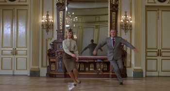Movie still from “Xanadu” (1980), directed by Robert Greenwald – A man and a woman are dancing in front of a mirror; Wide shot, Low angle
