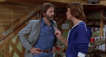 Movie still from “Xanadu” (1980), directed by Robert Greenwald – A man and a boy talking to each other; Medium shot, Over the shoulder angle