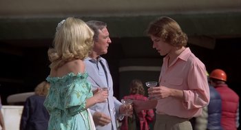 Movie still from “Xanadu” (1980), directed by Robert Greenwald – A group of people standing next to each other holding wine glasses; Medium shot, Over the shoulder angle