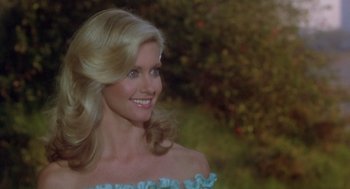 Movie still from “Xanadu” (1980), directed by Robert Greenwald – A woman with long blonde hair wearing a blue dress; Close Up shot, Over the shoulder angle