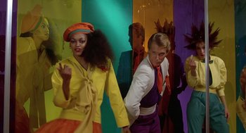 Movie still from “Xanadu” (1980), directed by Robert Greenwald – A group of people standing in front of each other; Medium shot, Low angle