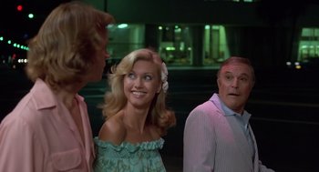 Movie still from “Xanadu” (1980), directed by Robert Greenwald – A group of people that are standing up; Medium shot, Over the shoulder angle