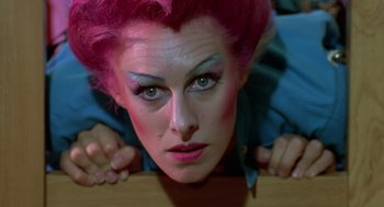 Movie still from “Xanadu” (1980), directed by Robert Greenwald – A woman with pink hair and blue eye shadow; Close Up shot, Overhead angle