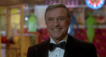 Movie still from “Xanadu” (1980), directed by Robert Greenwald – An older man in a tuxedo smiling for the camera; Close Up shot, Low angle