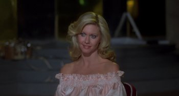 Movie still from “Xanadu” (1980), directed by Robert Greenwald – A woman with blonde hair wearing a pink dress; Close Up shot, High angle