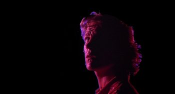 Movie still from “Xanadu” (1980), directed by Robert Greenwald – A man is looking up in the dark; Close Up shot, Low angle