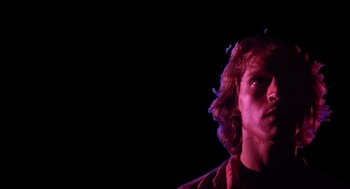 Movie still from “Xanadu” (1980), directed by Robert Greenwald – A person in a dark room; Close Up shot, Low angle